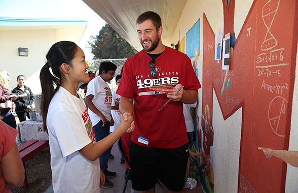 TE Garrett Celek partners with a Cabrillo Middle School student to tackle some math equations.