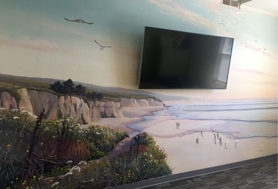 California seascape mural with painted seagulls flying above cliffs