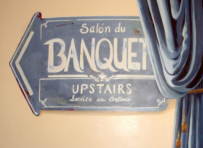 TrompeL OeilCurtainsandFrenchBistroSign Close up scaled 1